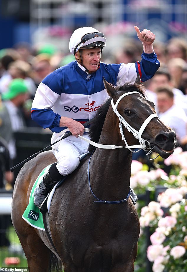 James McDonald riding Atishu celebrates winning the TAB Empire Rose Stakes on Derby Day