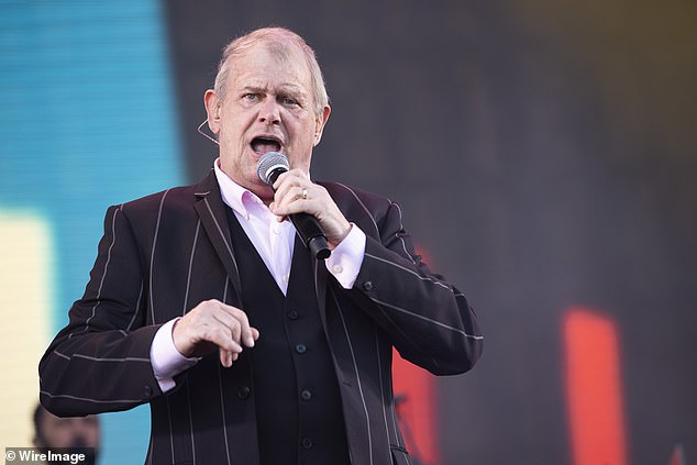 Australian music legend John Farnham stepped out to watch British superstars Coldplay wow fans at Melbourne's Marvel Stadium on Sunday. Pictured: Farnham performing in 2020