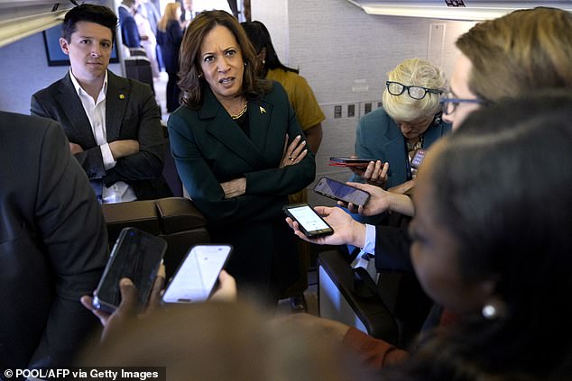 US Vice President and Democratic presidential candidate Kamala Harris speaks to members of the press aboard Air Force Two