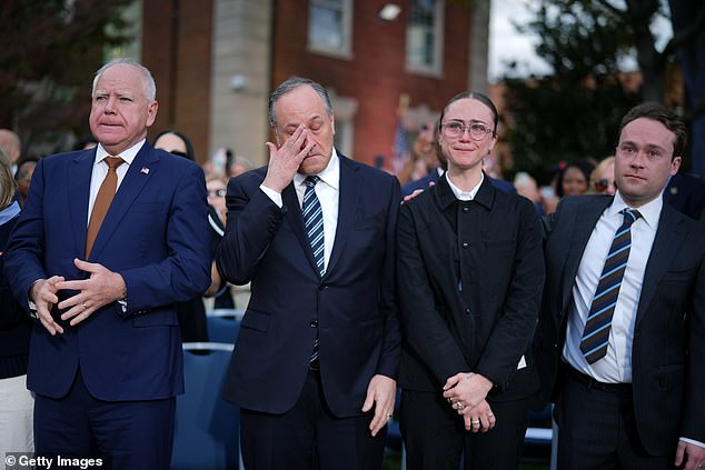 The Second Gentleman, seen here alongside his son and daughter Cole and Ella and Governor Walz, wipes away a tear as his wife speaks