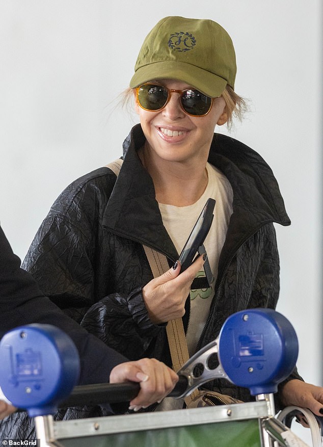 Kylie Minogue tried to go incognito as she landed at Sydney airport on Friday