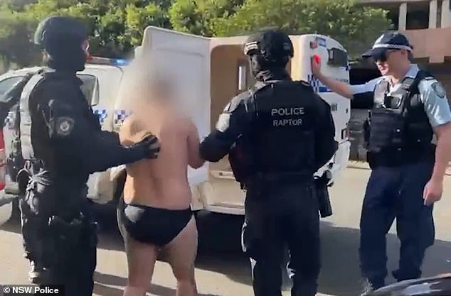 Video of the arrest shows the man being walked out of the unit block by Strike Force detectives while barefoot and wearing only his underwear (pictured)