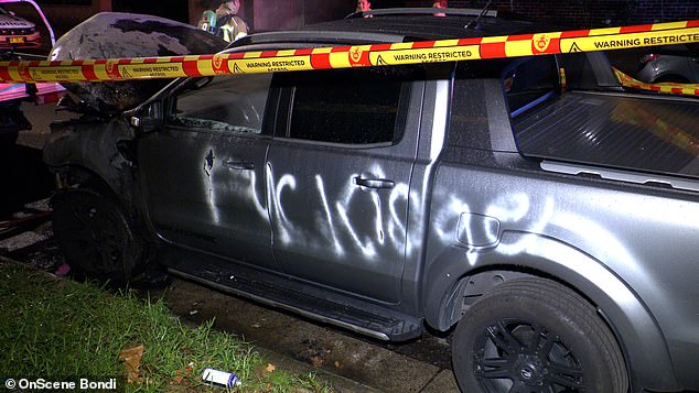 A man has been charged after more than a dozen cars and several buildings were defaced with anti-Israel slurs in one of Sydney's wealthiest suburbs