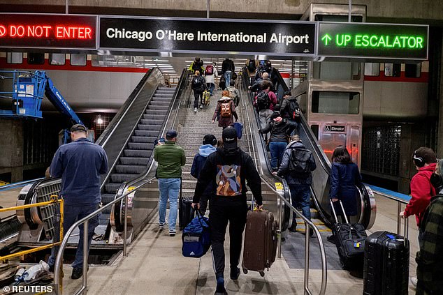 New maps have revealed how chaotic Thanksgiving travel will be as wintry weather complicates travel (file image of rush hour at Chicago O'Hare train station)