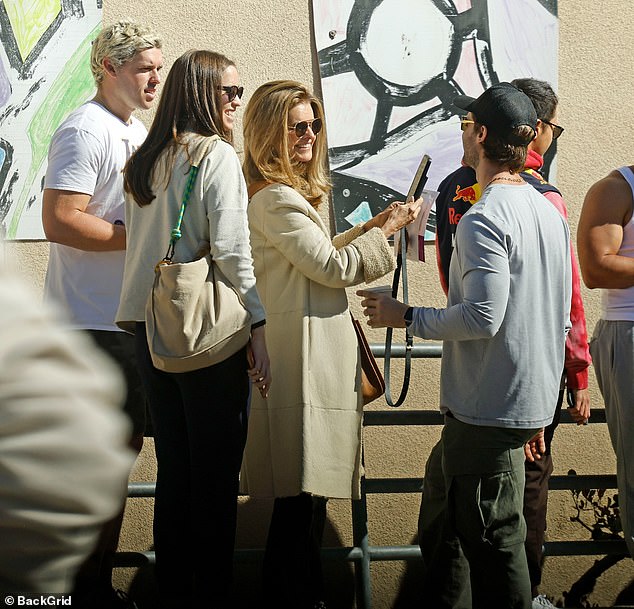 Maria Shriver, 68, was pictured waiting to vote with son Christopher Schwarzenegger, 27, and daughter Christina, 33, in Los Angeles on Tuesday. While waiting in line, she also came across her son Patrick, 31, who was leaving