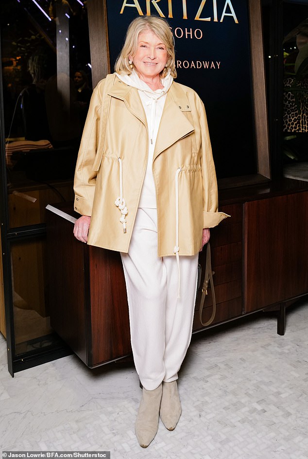 Martha Stewart, 82, stuns in a cream-colored hooded pantsuit at the grand opening of Aritzia's flagship store Thursday night in New York City. She stepped out in taupe ankle boots and covered up with a camel all-weather jacket