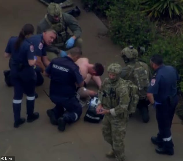 The alleged gunman, 26, remains in hospital after being bitten by a police dog during arrest