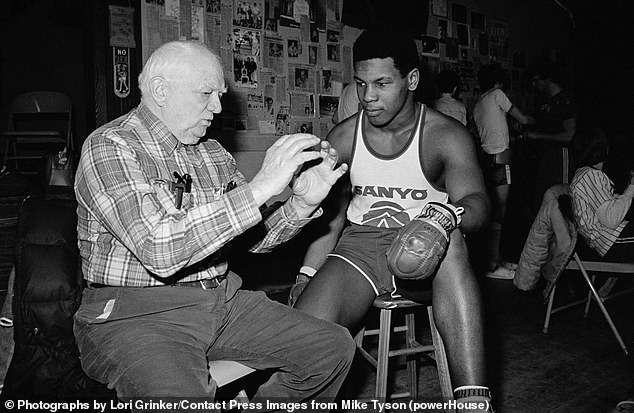 Boxing trainer Cus D'Amato transformed the young Mike Tyson (pictured together) into a boxing phenomenon