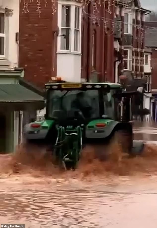 This is the moment a tractor driver sent a 'wave of water' through shop windows today