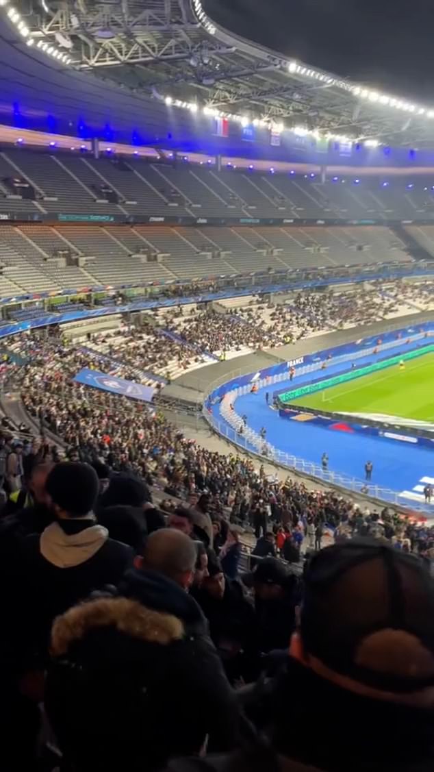 Mobile phone footage shows fans fleeing their seats at the Stade de France after an alleged fight in the first half