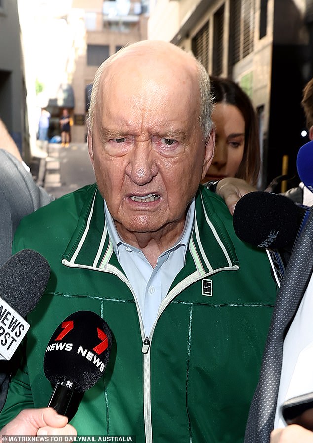 Jones is pictured in an emerald green ensemble, snapping at the waiting media pack as he left the Day Street police station on Monday afternoon.