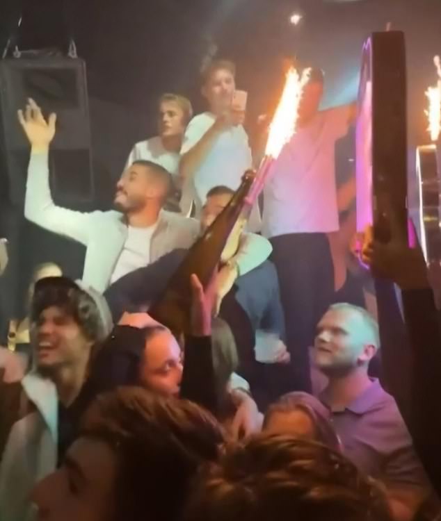 A group of Leicester players, including Harry Winks (behind the bottle) and Conor Coady (left), were spotted cheering just hours after their 2-1 defeat to Chelsea on Saturday.