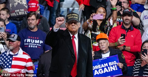 Former US president and Republican presidential candidate Donald Trump pumps his fist after a speech at the end of a campaign rally at the Atrium Health Amphitheater in Macon, Georgia, on November 3, 2024. (Photo by Elijah Nouvelage / AFP) (Photo by ELIJAH NOUVELAGE/ AFP via Getty Images)