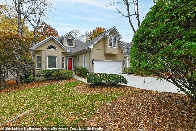 A charming North Carolina home has hit the market with an extraordinary feature in the photos: a huge giraffe that seems to burst through the walls of the foyer