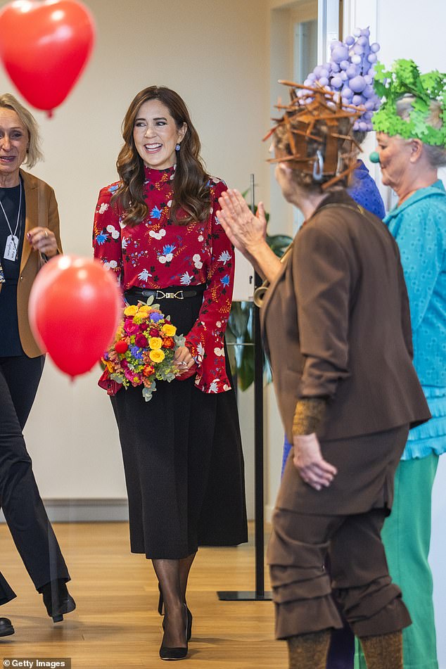 The royal, 52, arrived at the event with a big smile on her face as she was presented with a bouquet of flowers by some of the staff