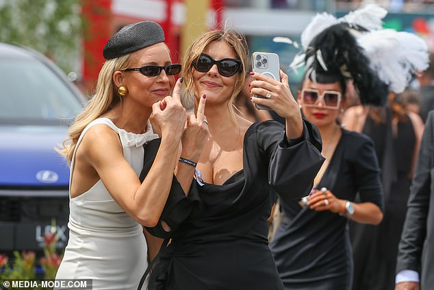 Melbourne radio stars Carrie Bickmore and Lauren Phillips flipped the bird as they arrived on Derby Day on Saturday