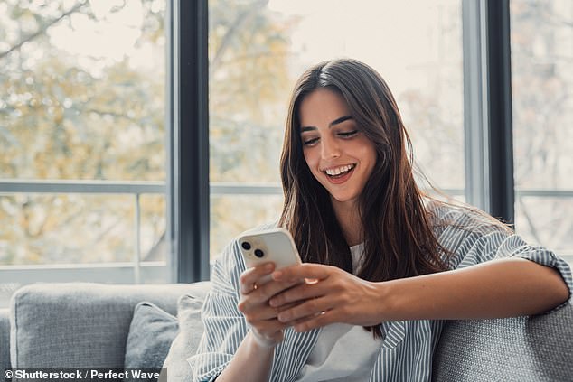 Ofcom's latest report on UK internet habits shows that women spend 33 minutes longer online than men every day. In 2024, the average woman spent four hours and 36 minutes on her devices (stock photo)