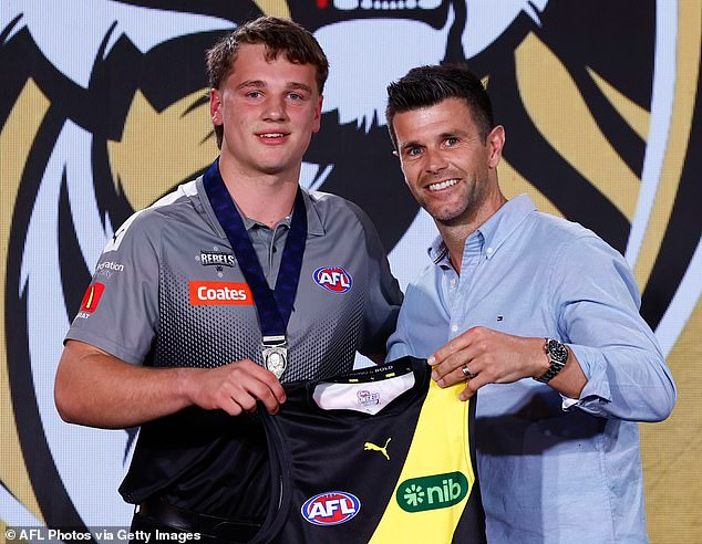 The number one pick in the draft, Sam Lalor (left), was presented with his Richmond guernsey by club legend Trent Cotchin (right)