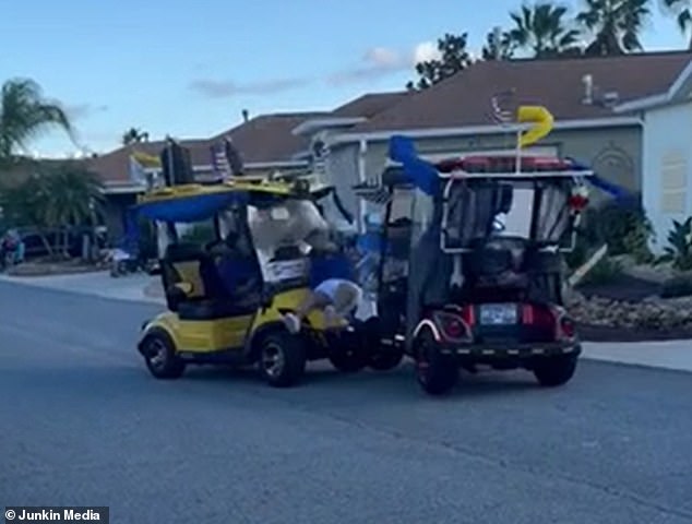 Video footage captured the shocking moment two golf carts collided head-on while participating in a parade in Florida, sending one of the drivers flying out of his seat and into the windshield of the opposing cart.