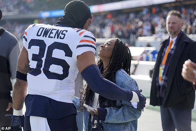 Simone Biles and Jonathan Owens share a moment on the sidelines before Bears vs Vikings