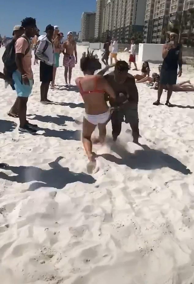 A resurfaced video of a man tackling a bikini-clad woman has gone viral on social media