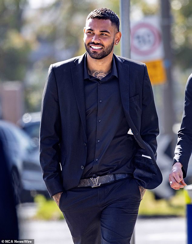 Thomas is pictured laughing outside a Melbourne court on Thursday after police dropped charges against him