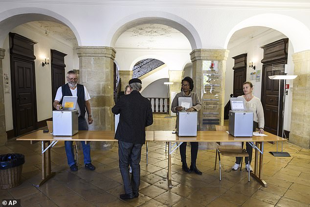 The Swiss People's Party (SVP) – the largest in the four-party ruling coalition – launched the anti-immigration initiative last year, which was signed by more than 115,000 residents and could come to the vote as early as 2026 (file image from a Swiss voter who voted during the federal elections in October 2023)