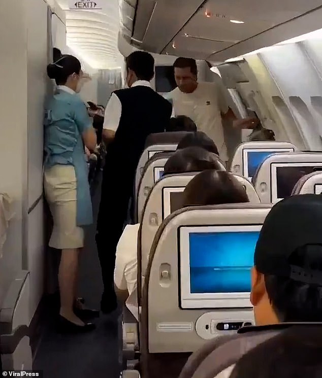 A passenger on a flight to South Korea caused panic after allegedly trying to open a plane's emergency door mid-flight