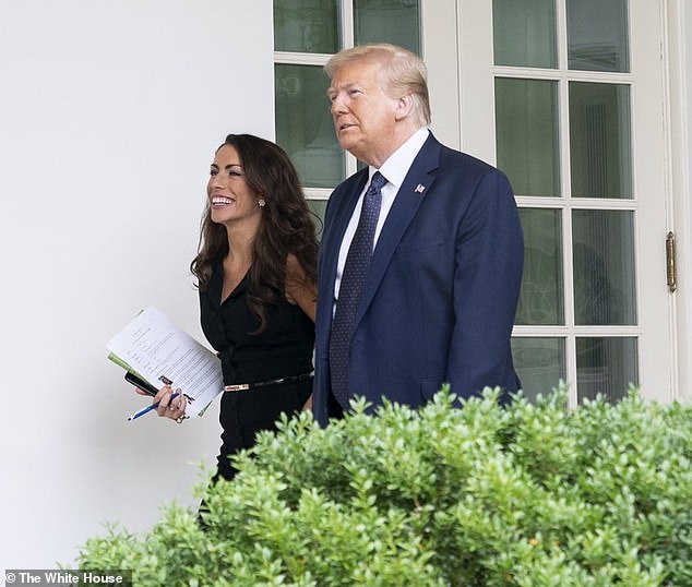 The former Donald Trump staffer, 35, said she switched sides and voted for Democratic candidate Kamala Harris because she was disappointed by Trump and the Republican Party's 'inability to rebuild' - pictured with Trump in 2020