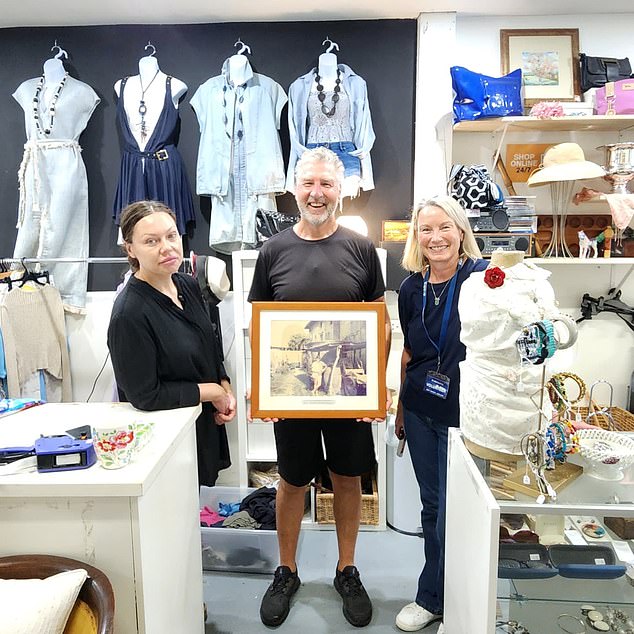 Rob Klaric of the Lifeline Mosman staff after finding two framed photos of him and his wife on a European vacation 30 years ago in the store