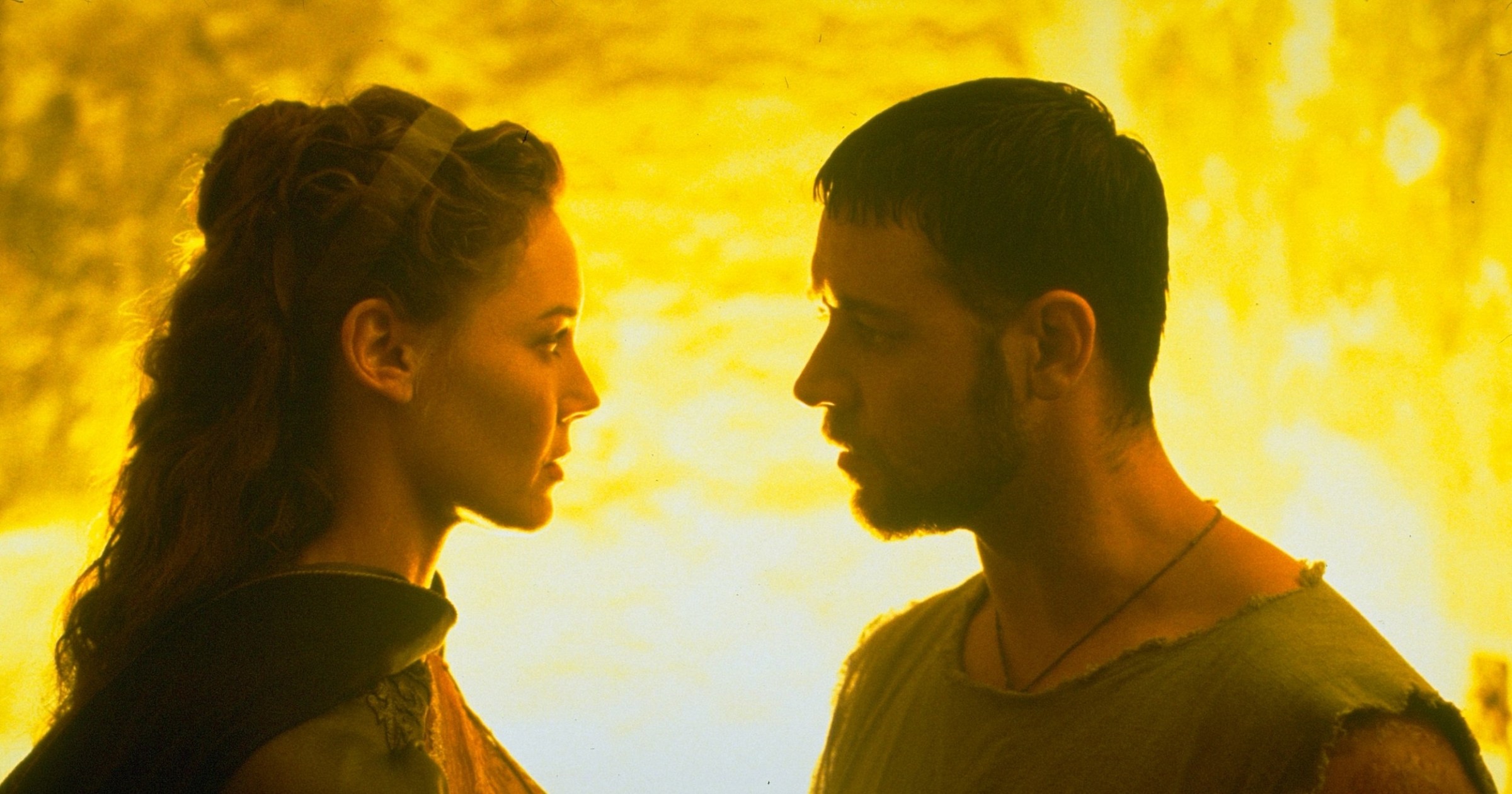 The emperor's daughter Lucilla (Connie Nielsen) faces gladiator Maximus (Russell Crowe) in a close-up backlit with fiery yellow light in 2000's Gladiator