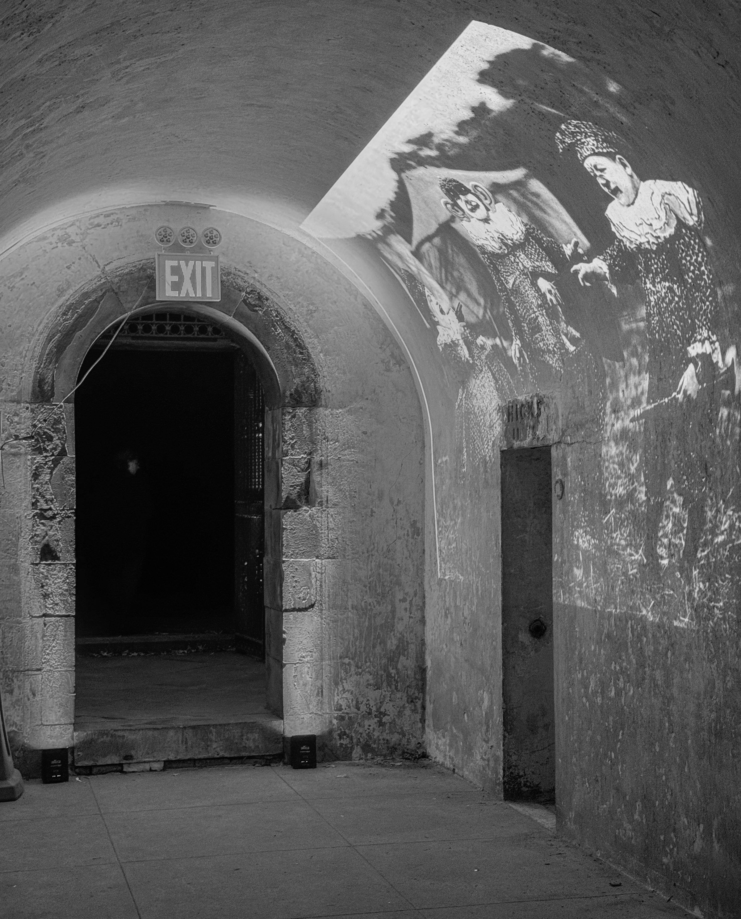 The entranceway, with a projection of old clowns, from Margaret Leng Tan's October 3, 2024 performance of Curios in the Catacombs at Green-Wood Cemetery in New York