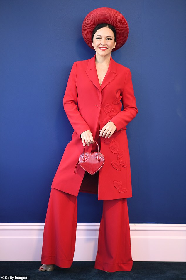 Racing enthusiast Viera Macikova leads the trend in a scarlet suit with matching hat and heart-shaped bag