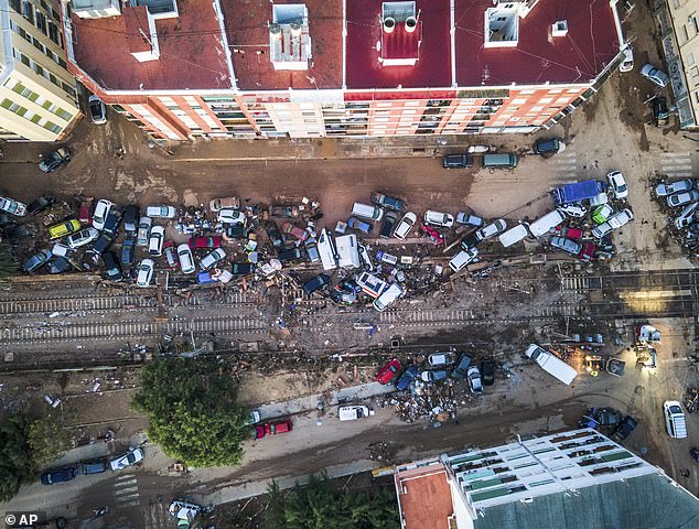 Vehicles are piling up in the streets caused by the storm late Tuesday and early Wednesday that left hundreds dead or missing in Alfafar, Valencia