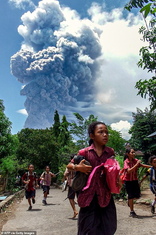 Schoolchildren were seen running from Mount Lewotobi Laki-Laki in Indonesia when it first erupted (pictured)