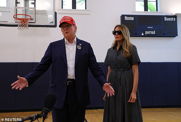 Republican presidential candidate and former US President Donald Trump, accompanied by former US first lady Melania Trump, speaks to reporters as he votes at the Mandel Recreation Center on Election Day in Palm Beach, Florida, USA, November 5, 2024. Trump was asked if he will tell his supporters not to be violent, to which he replied that there is no need