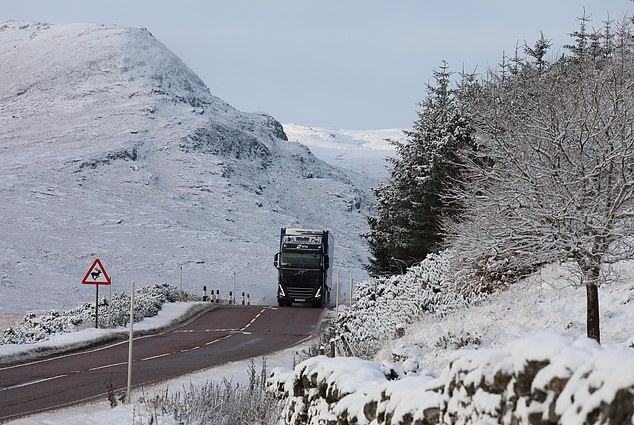 Pictured this morning, a truck on a snow-covered A835 near Loch Dorma in the Scottish Highlands