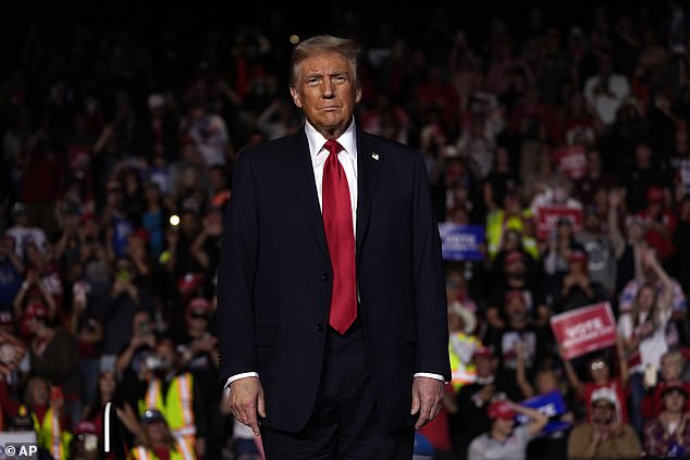 Trump pauses during a campaign rally on Oct. 31, 2024, in Nevada, looking quite tanned