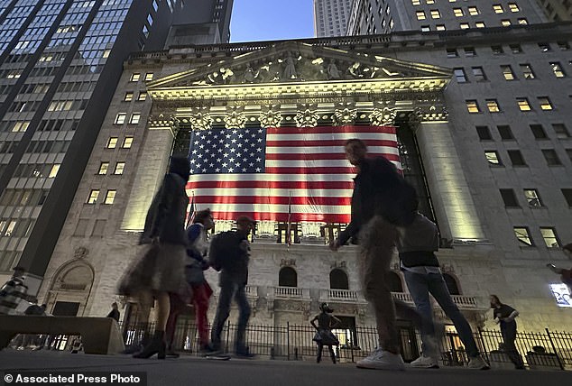 People pass by the New York Stock Exchange in New York's Financial District on Tuesday, November 5, 2024. Stocks rose Wednesday morning after Trump regained the presidency