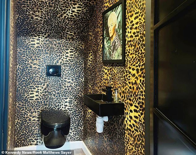 The Pat Butcher-themed bathroom, covered in leopard print wallpaper