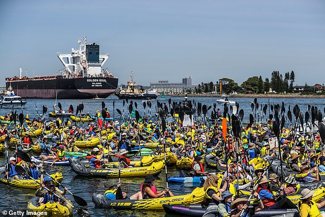 There were about 150 people waving anti-coal signs and paddling into the canal in kayaks. Police used jet skis and police boats to arrest the protesters (photo demonstrators gathered at Newcastle Harbour)