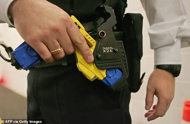 A man was tasered and pepper-sprayed by arresting police after allegedly stabbing a woman he knew on a train (stock image of taser shown)