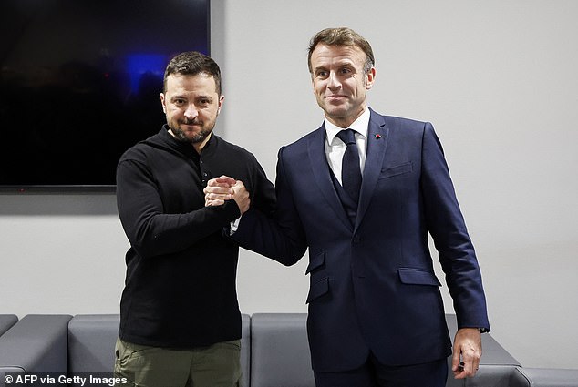 Volodymyr Zelensky was pictured today holding hands with French President Emmanuel Macron