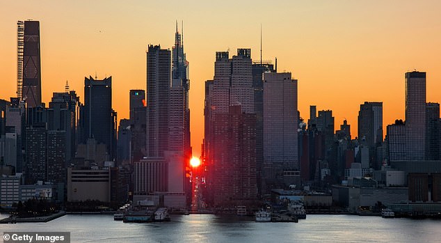 Despite being the most populous city in the US, New York is a state where many lifelong residents are fleeing for cheaper real estate (Photo: The sun rises over 42nd Street in Manhattan in a phenomenon known as Manhattanhenge on November 30, 2024)