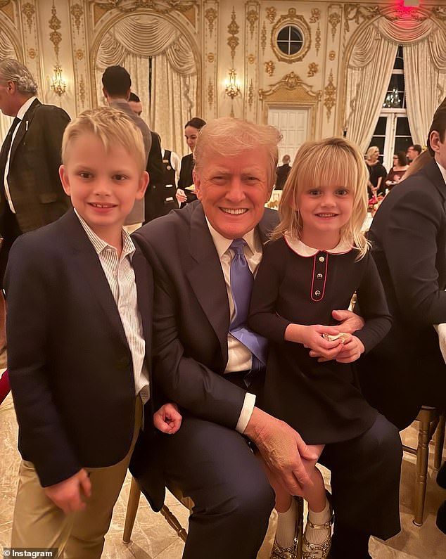 Trump poses with two children of Eric and Lara