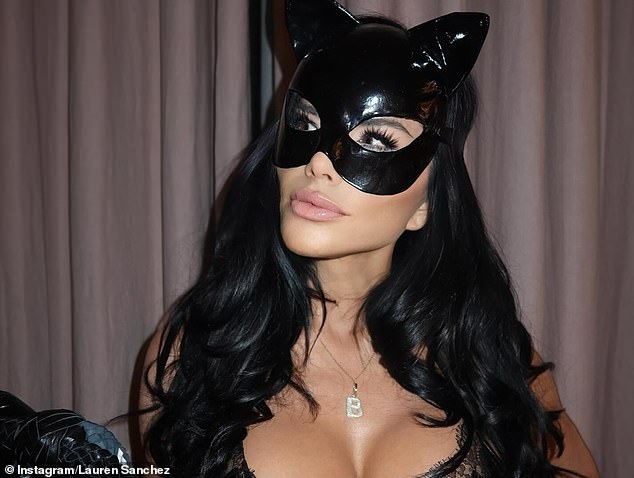 The 54-year-old businesswoman stunned in a black latex cat costume complete with whip and a diamond-encrusted 'B' pendant necklace