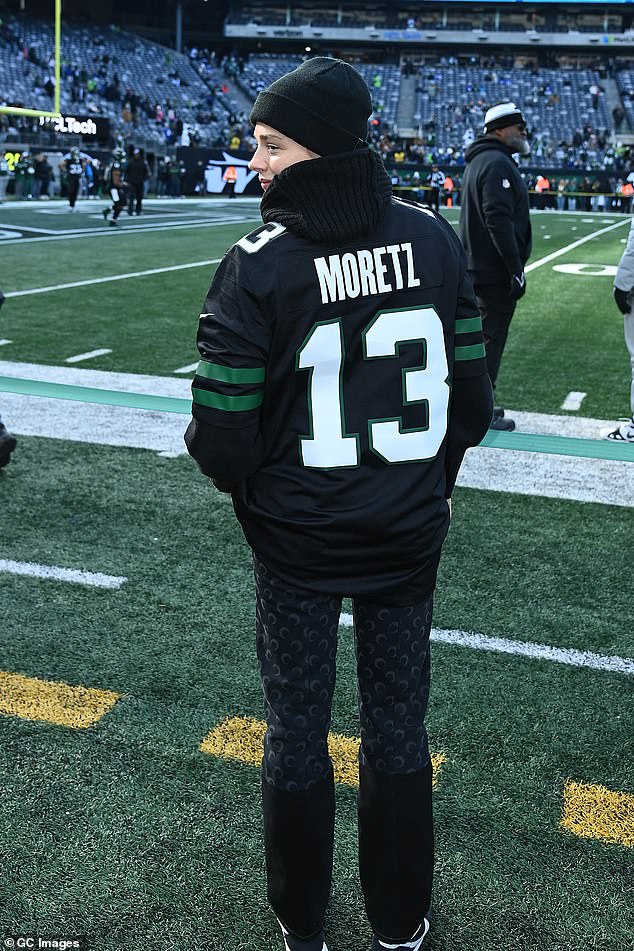 She seemed in good spirits while modeling a custom New York Jets jersey