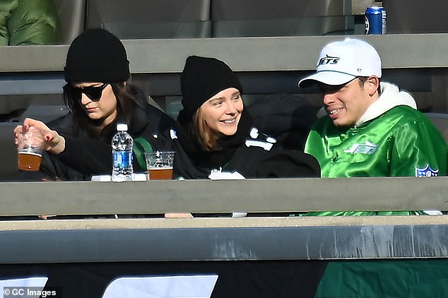 Hauser, Moretz and Harrison were seen sipping beers and enjoying the match together