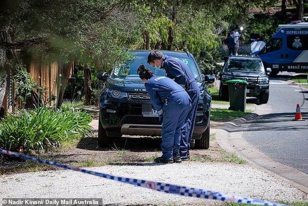 Forensic officers are investigating a car with a P license plate that was parked outside the building