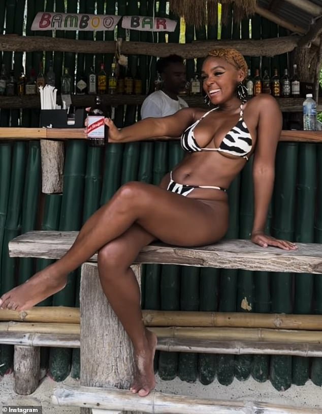 She enjoyed time at a cabin bar looking like magazine cover while sipping a foreign bottle of beer